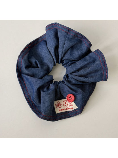 Blue scrunchie and headband set arranged side by side on white background