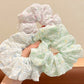 Gifty scrunchie with small floral pattern wrapped around a ponytail