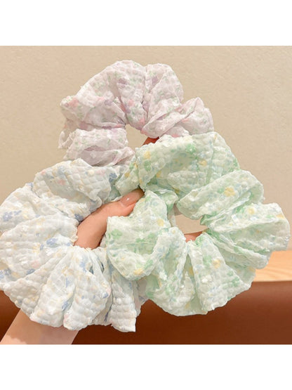 Gifty scrunchie with small floral pattern wrapped around a ponytail