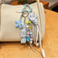 Blue candy star-shaped keychain with a silver keyring on a white background