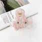 Beau vintage double flower hair claw clip displayed on a wooden surface