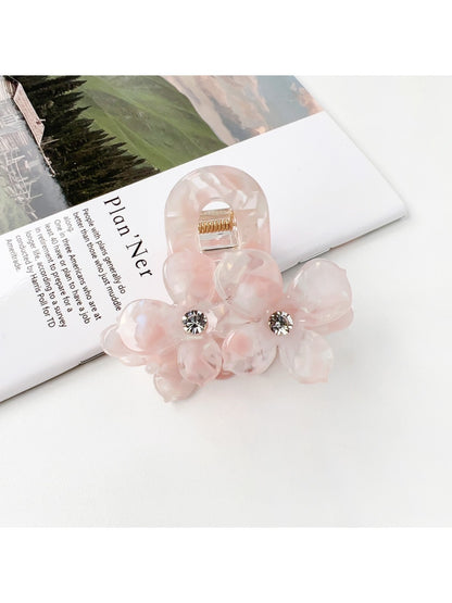 Beau vintage double flower hair claw clip displayed on a wooden surface