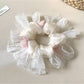 Gifty minimalist floral scrunchie with white and yellow flower pattern on beige fabric