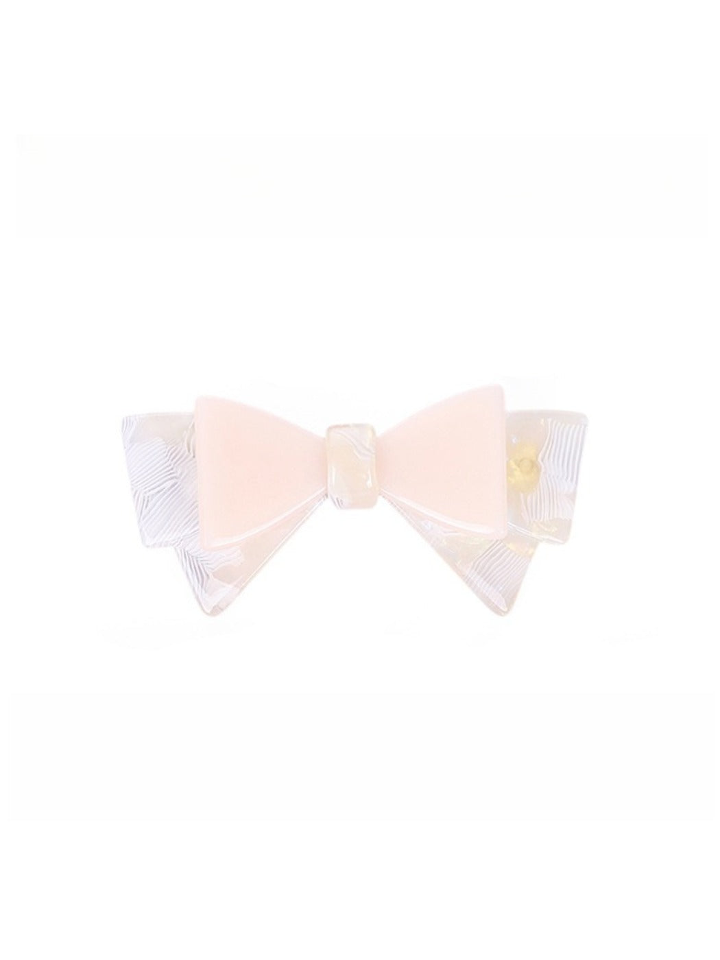 Beau hair clip with bow held in hand to show size and scale