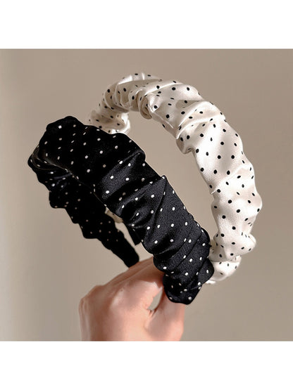 Gifty minimalist pleated headband with black and white polka dot pattern on a white background