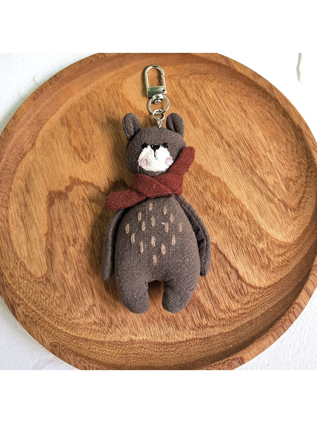 Bear keychain attached to a backpack zipper pull