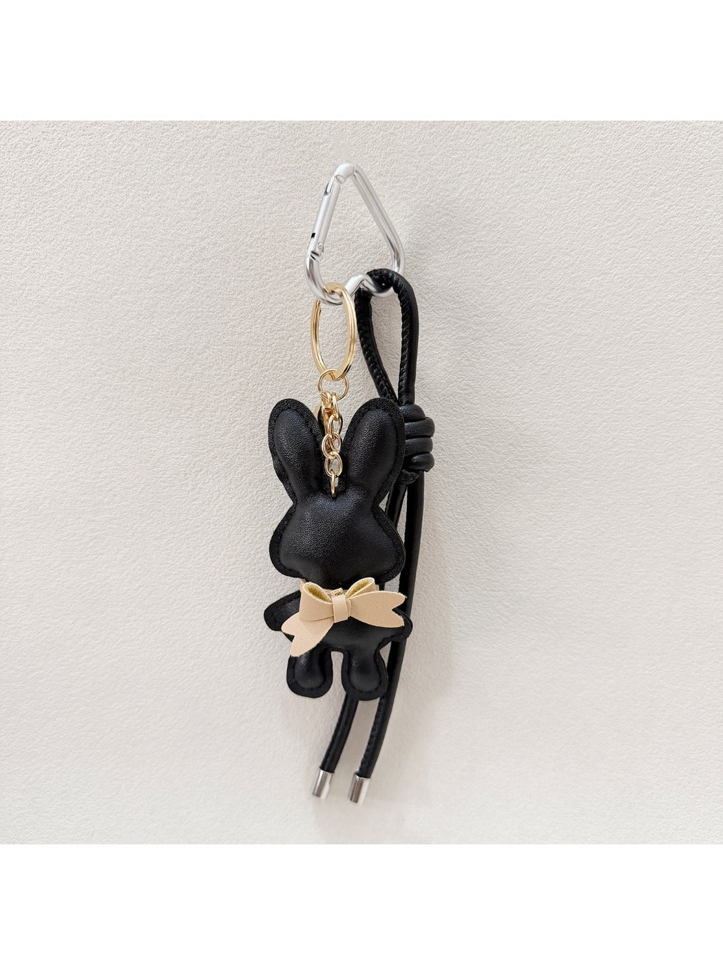 Bunny keychain placed next to a smartphone for size comparison