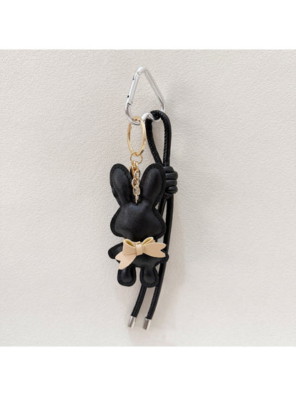 Bunny keychain placed next to a smartphone for size comparison