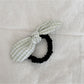 Gifty plaid hair tie with red bow displayed alongside other hair accessories
