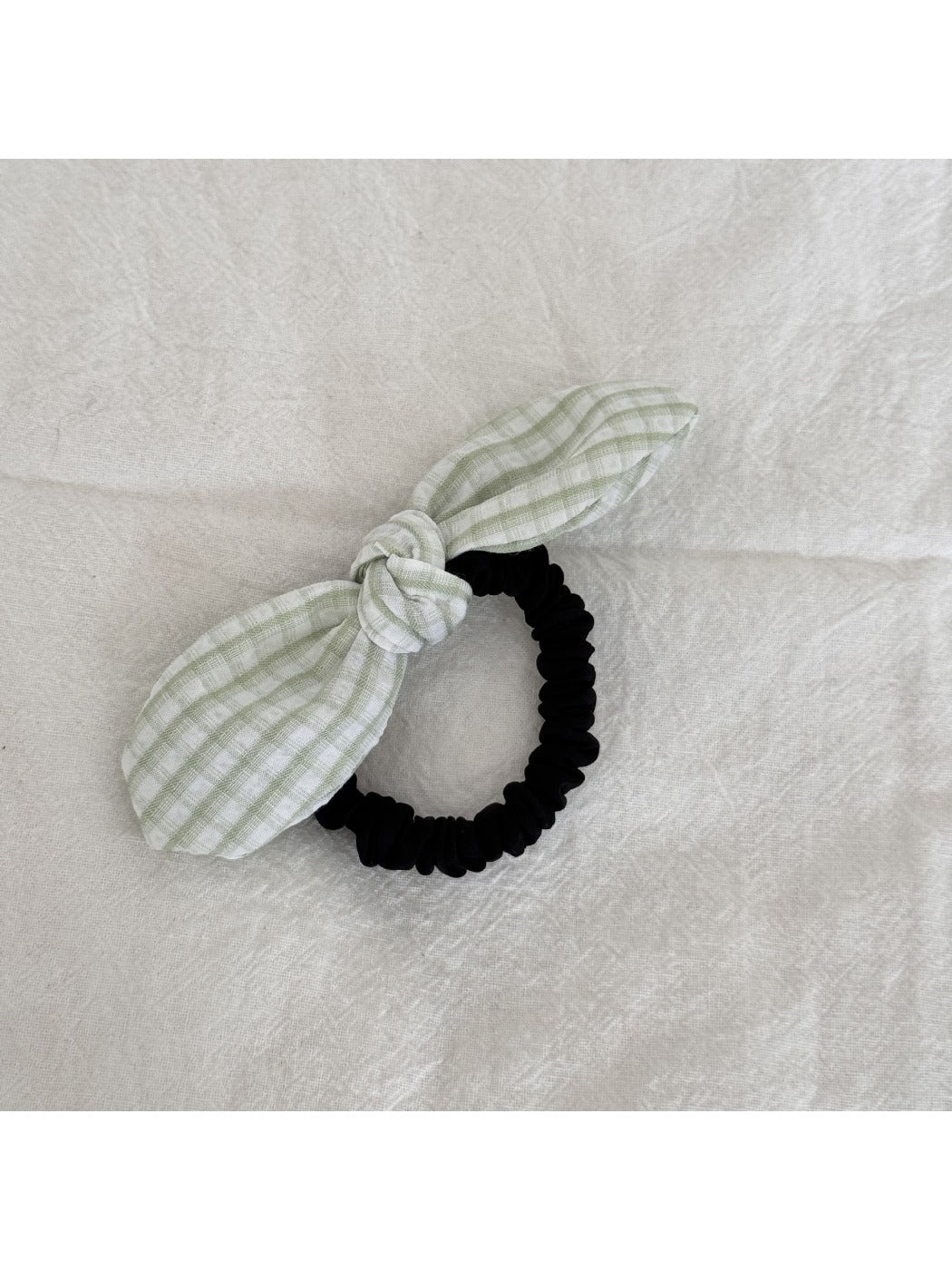Gifty plaid hair tie with red bow displayed alongside other hair accessories