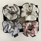 Close-up of Gifty soft playful striped scrunchie in pastel colors on white background