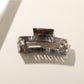 Beau rectangular hair clip worn in long brown hair, securing a half-up hairstyle