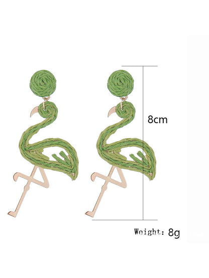 Flamingo shaped pendant earrings hanging from a silver hook