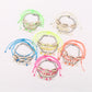 Lovra stylish beach style bracelet with blue and white beads on a sandy background