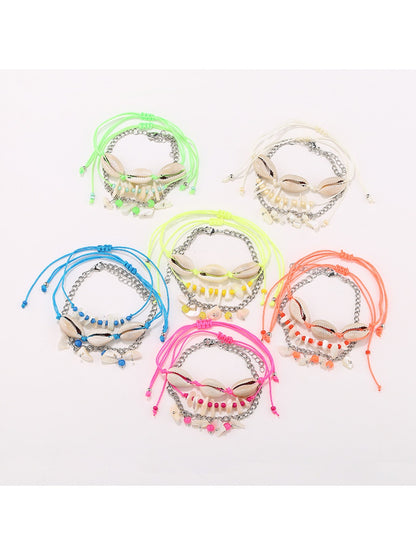Lovra stylish beach style bracelet with blue and white beads on a sandy background