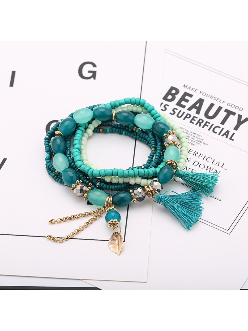 Side view of Lovra tassel pendant bracelet displaying bead texture and tassel