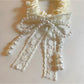 Model wearing Gifty Sweet Beaded Bow Hair Tie holding hair in a ponytail