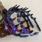 Blue scrunchie made of soft fabric with gathered elastic design