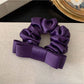 Model wearing the soft romantic charm scrunchie in a casual hairstyle