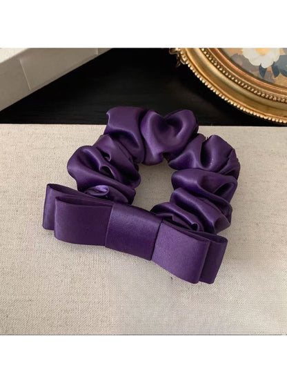 Model wearing the soft romantic charm scrunchie in a casual hairstyle
