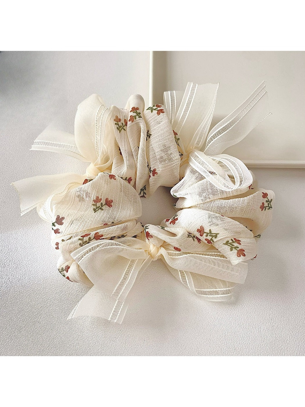 Top view of Gifty tiny floral print bow scrunchie showing fabric pattern