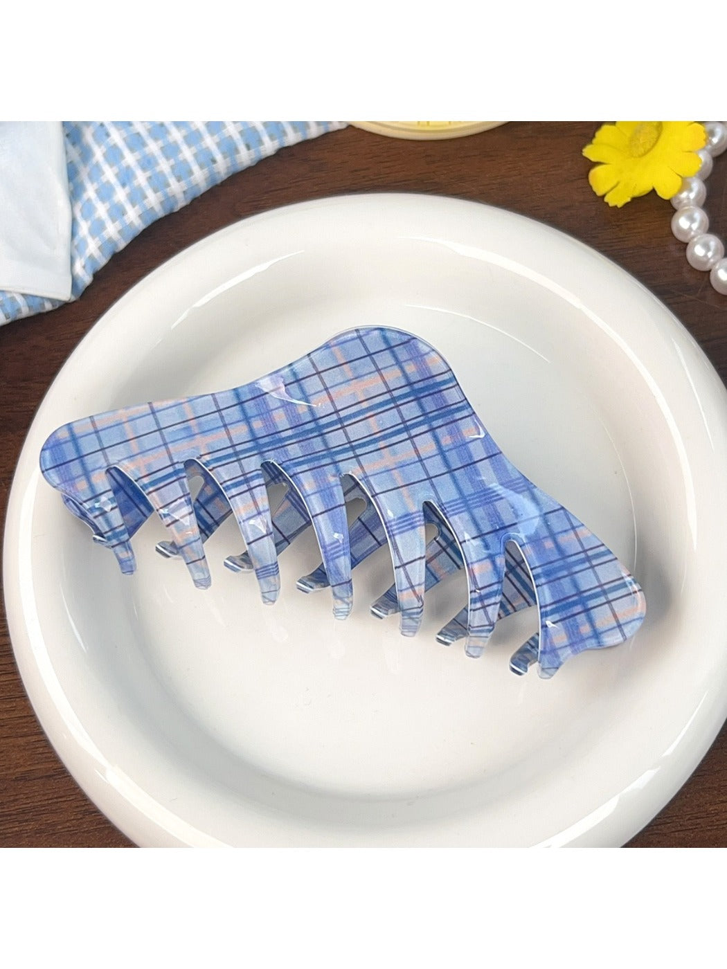 Top view of blue plaid shark hair claw clip with open jaws