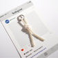 Side view of Keypus cute bow keychain highlighting bead texture and colors