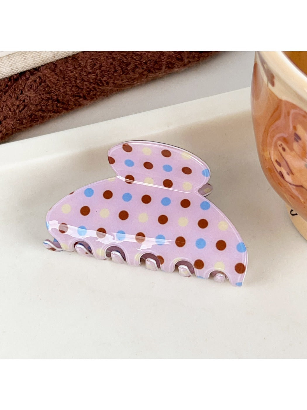Beau pink polka dot claw clip photographed with soft lighting to highlight color and pattern