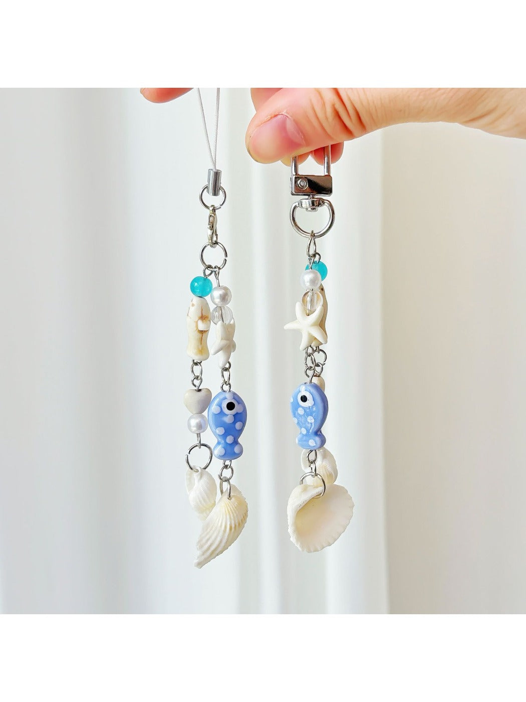 Blue fish-shaped keychain with a smiling face and textured scales