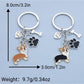 Both puppy and puppy paw keychains displayed on a wooden surface