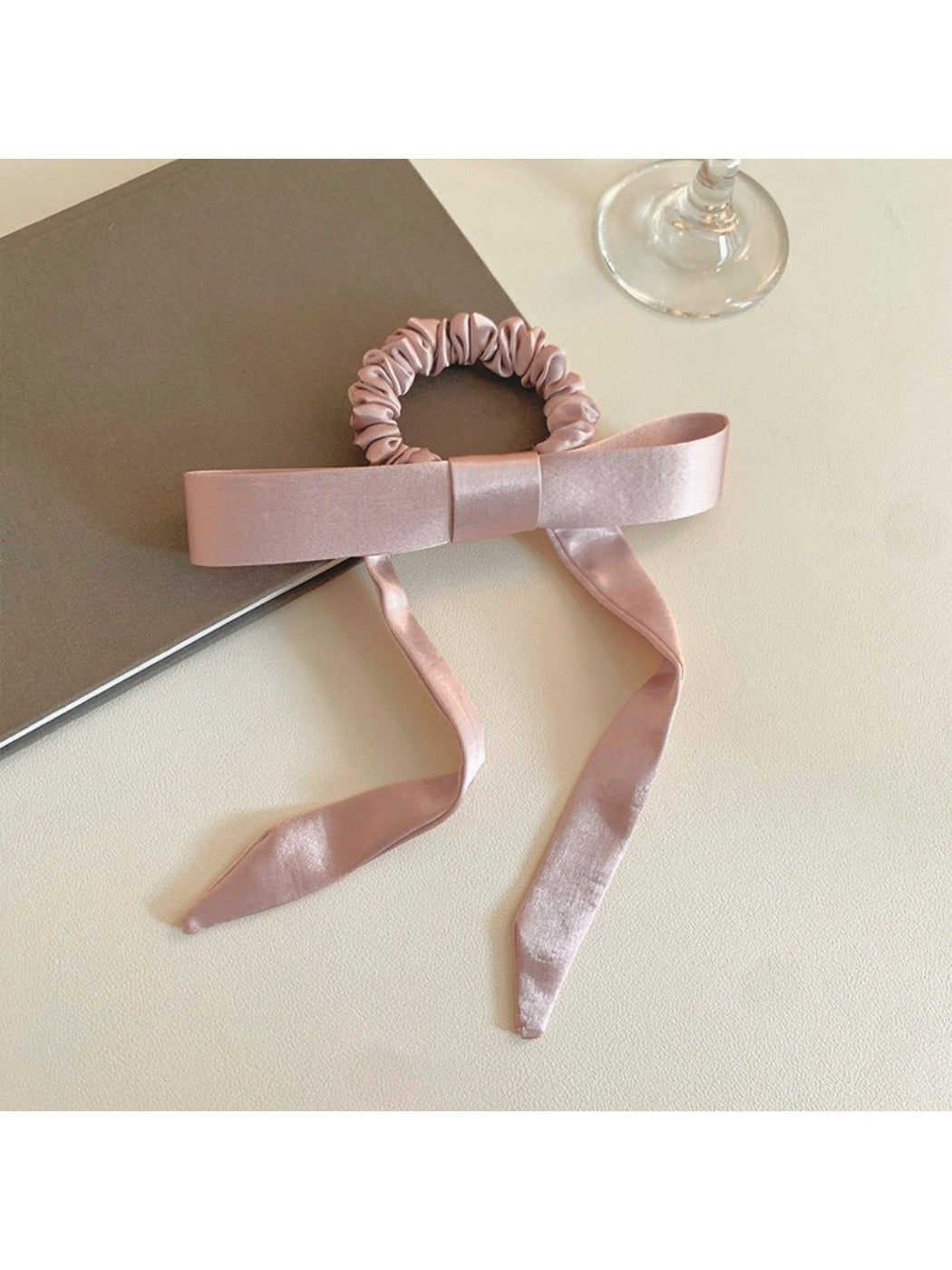 Model wearing the bow embellished hair tie styled with casual outfit and loose hair strands