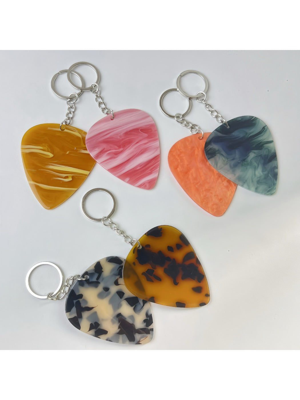 Keypus teardrop charm keychain hanging from a set of keys on a wooden surface