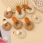 Close-up of Earedge elegant round drop earrings with silver finish on white background
