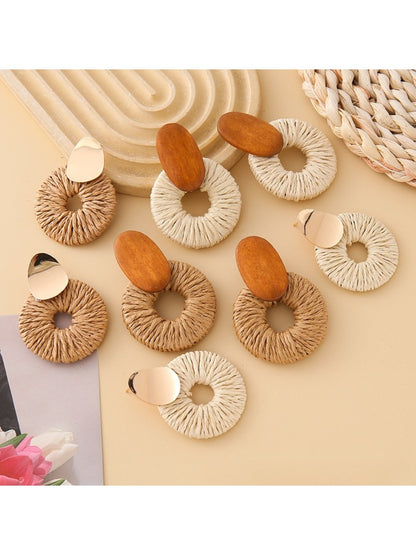 Close-up of Earedge elegant round drop earrings with silver finish on white background