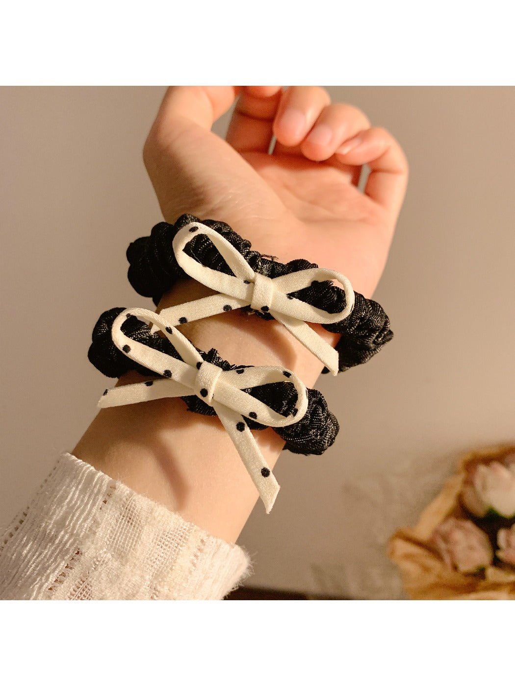 Side view of the vintage polka dot bow hair tie showing elastic band