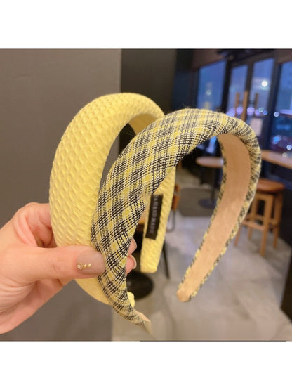 Side view of yellow bow headband on a model with dark hair