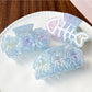 Side view of Beau sweet gradient blue claw clip highlighting curved teeth