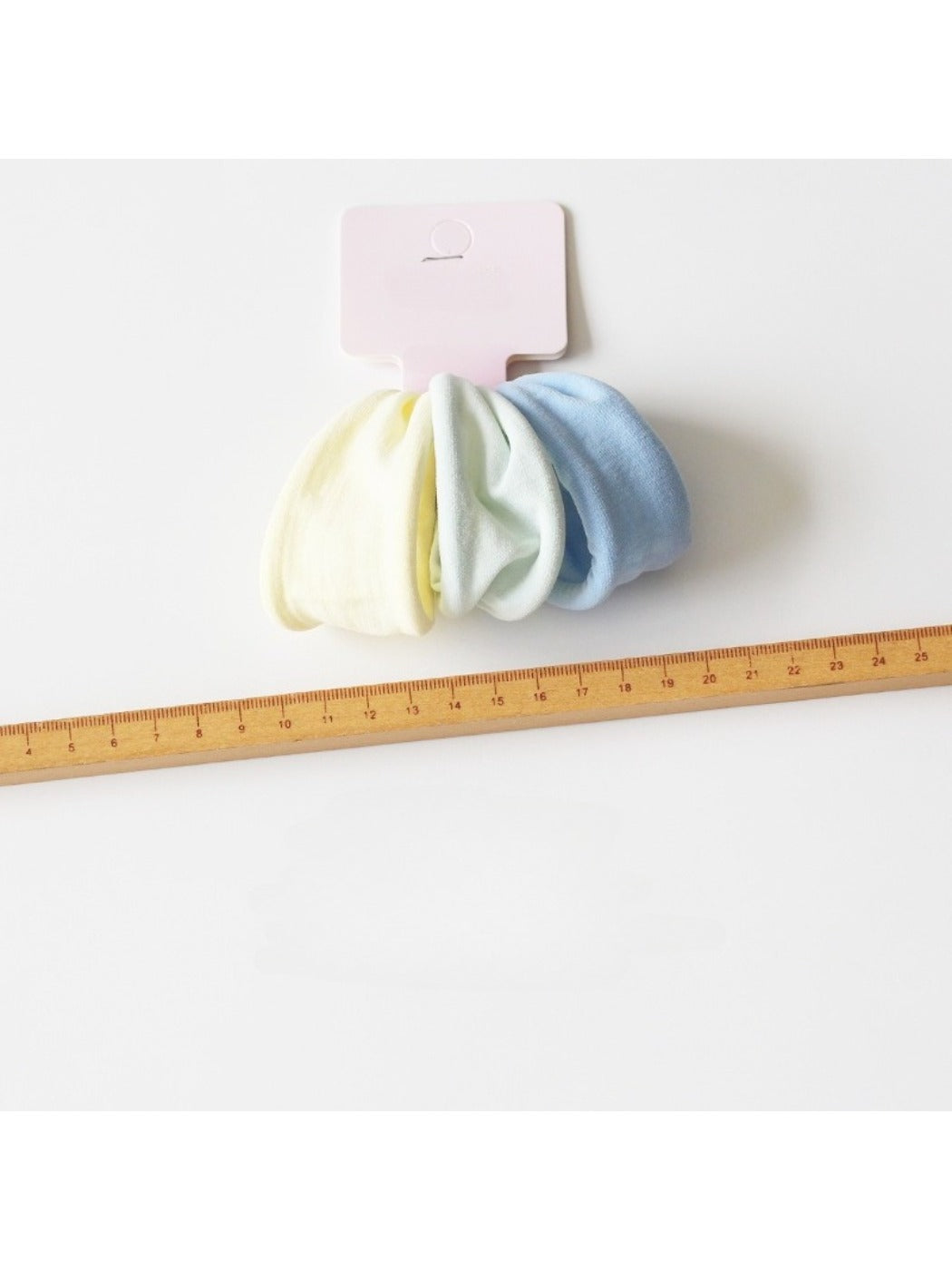 Hair ties wrapped around a wrist showcasing their stretch and minimalist design