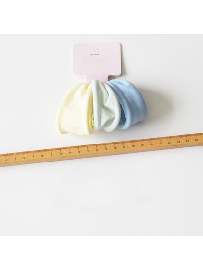 Hair ties wrapped around a wrist showcasing their stretch and minimalist design
