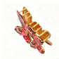 Side view of red butterfly hair clip highlighting clip mechanism