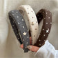 Close-up of a solid color star hairband with a stylish design on a white background