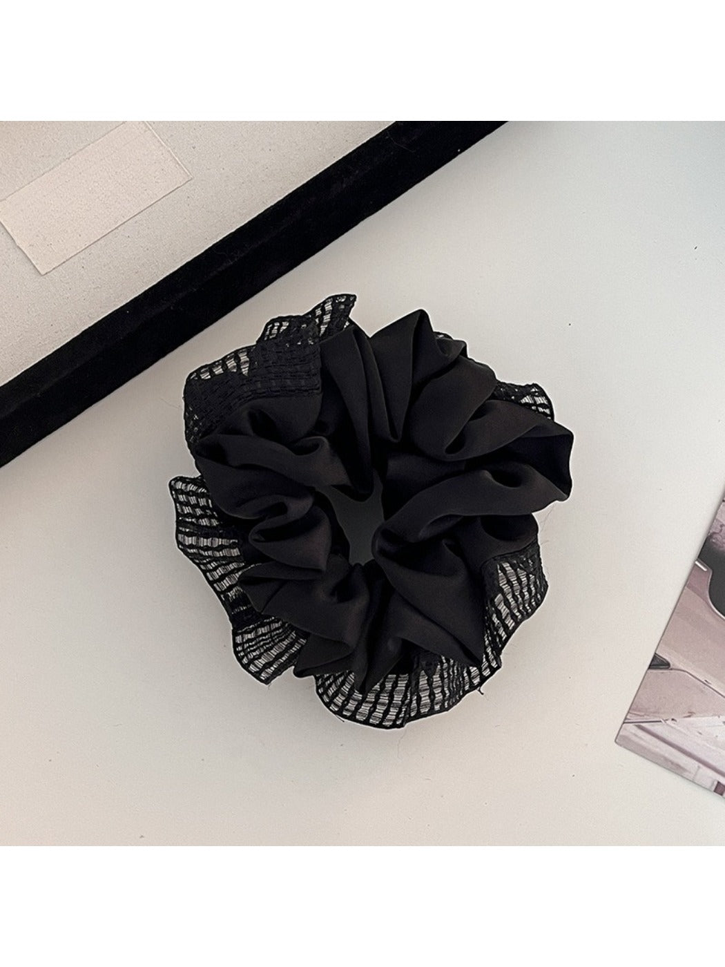 Side view of Gifty scrunchie showing gathered ruched fabric and cut out details