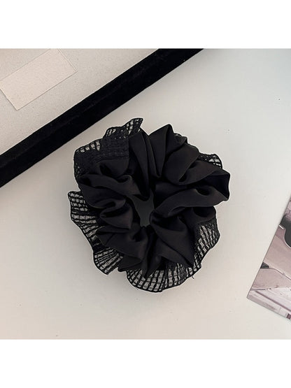 Side view of Gifty scrunchie showing gathered ruched fabric and cut out details