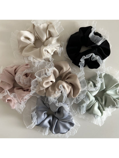 Close-up of Gifty vintage tulle ruffle scrunchie in soft pink fabric