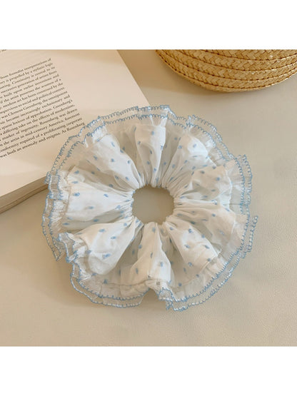 Scrunchie displayed on a white background highlighting ruffled design