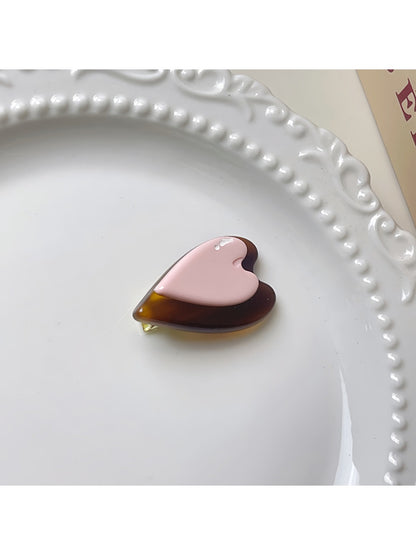 Beau hair clip placed on wooden surface with natural lighting