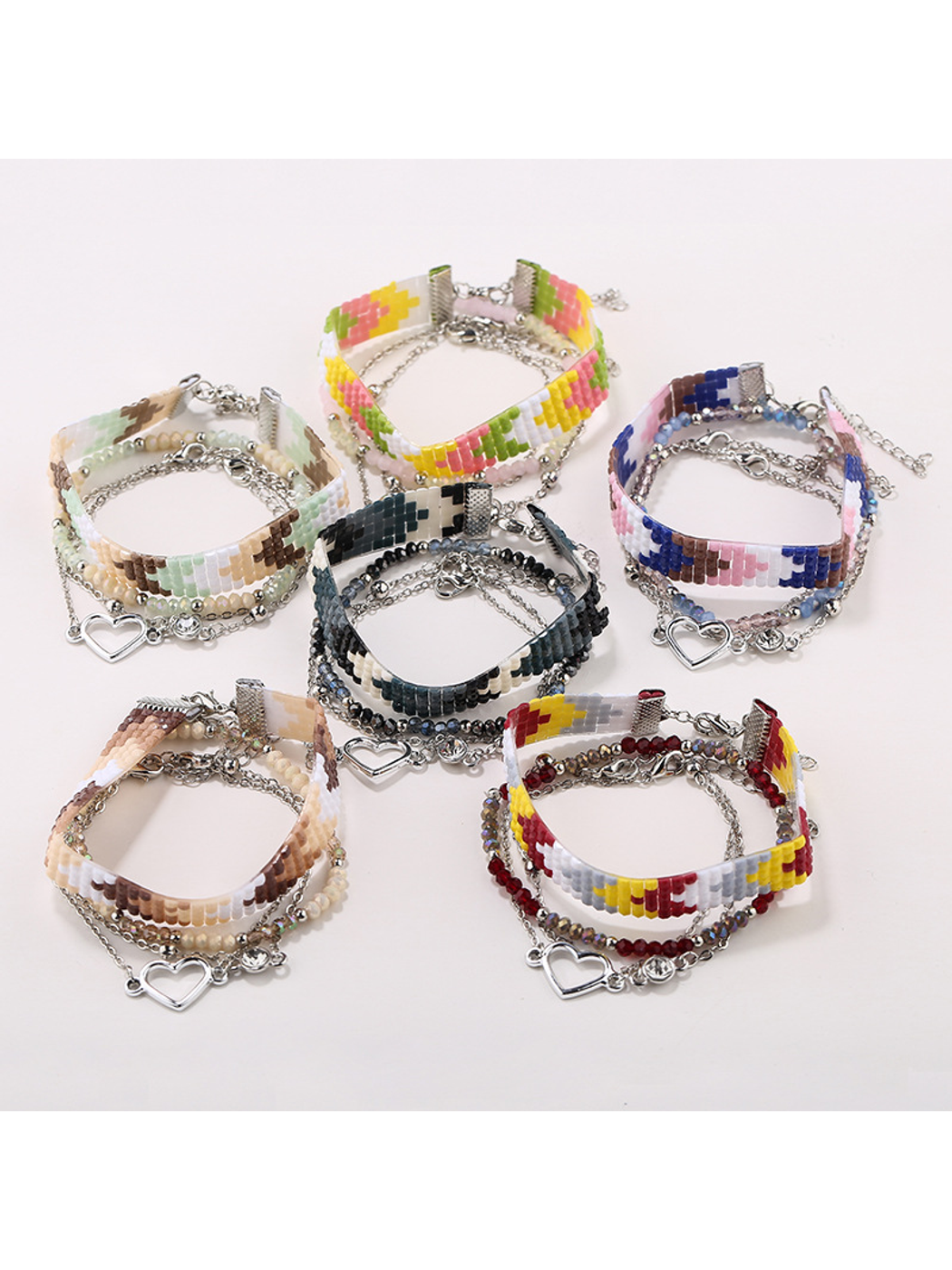 Close-up of Lovra boho stackable beaded bracelets in earthy tones on a wrist