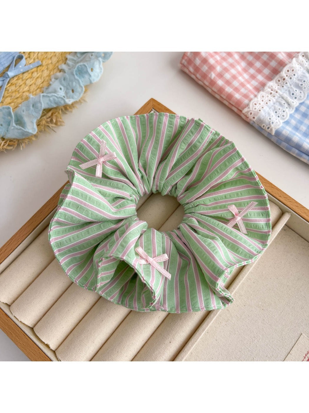 Gifty scrunchie placed next to matching hair accessories
