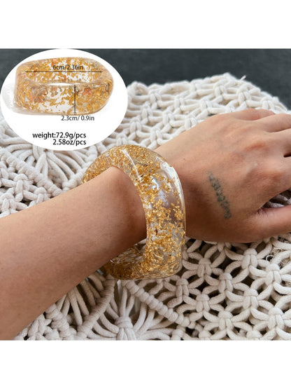 Lovra vintage wide irregular shaped bangle bracelet resting on textured surface