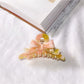 Beau acetate bow shaped claw clip photographed from low angle